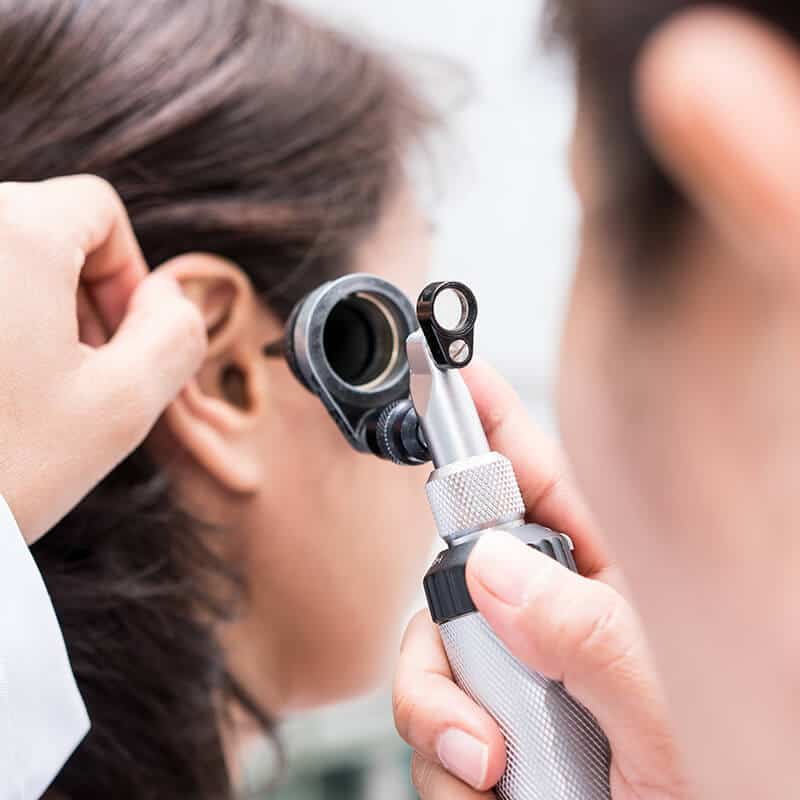 examining the ear with an otoscope
